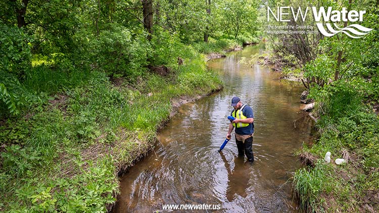 Watershed Specialist, Ben, taking samples